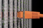Rows of server racks with status indicators lit inside a data centre hall