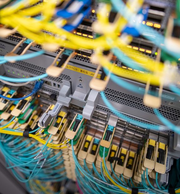 Dense yellow and blue fibre patch cords plugged into a core switch labelled RockCloud