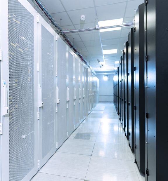 Cold aisle inside a RockCloud data centre, lined on both sides with live server racks