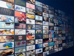 A curved wall of hundreds of screens playing on-demand and live programming